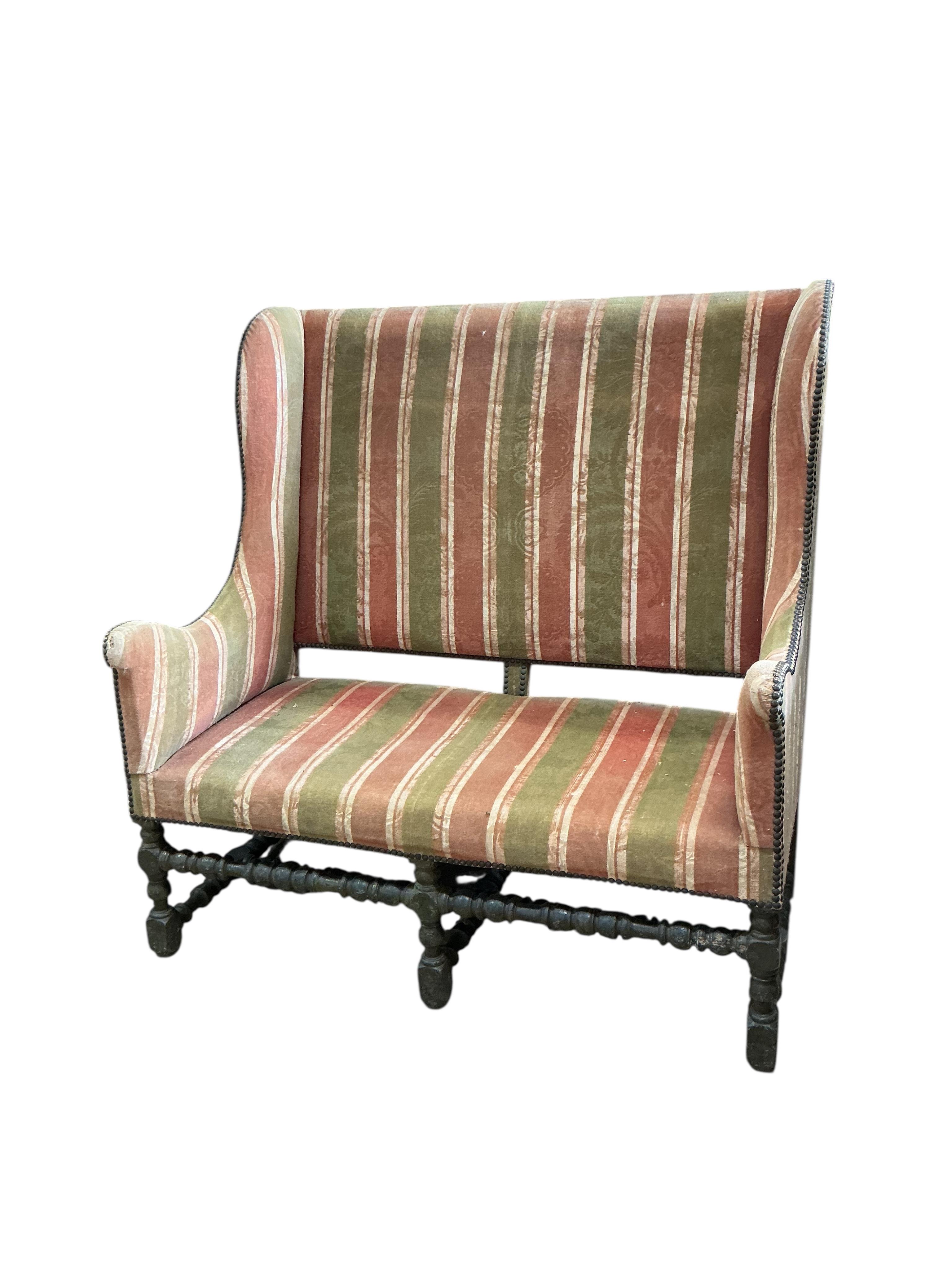 A mid 17th century upholstered high back settee on painted turned underframe. (Provenance, from the Great Hall, Luddesdown Court)
